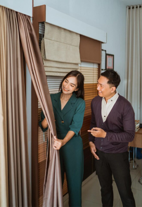 Curtain consultant helping customers choose drapes for interior design