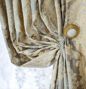 Close-up of luxury curtain fabric with decorative tieback and premium pattern